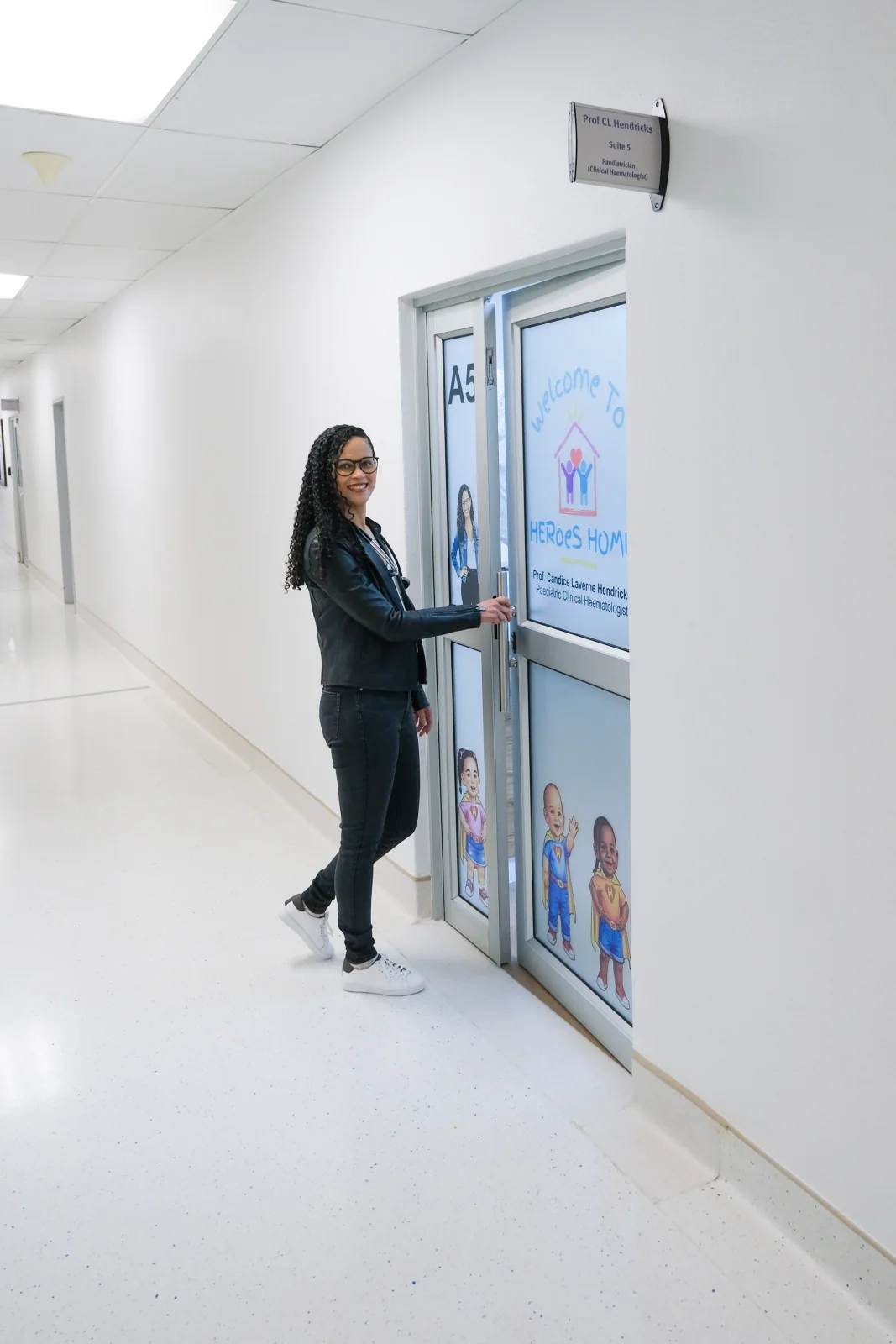 Prof. Candice Hendricks opening the HERoeS HOME Suite A5 door