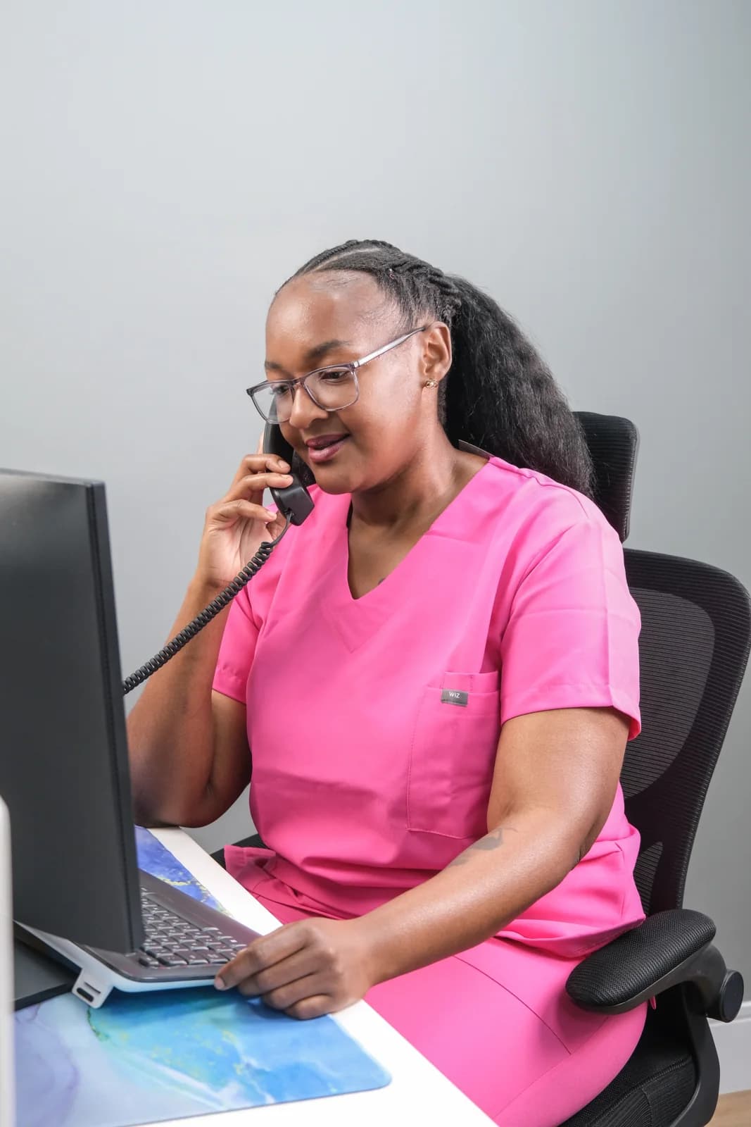 HERoeS HOME nurse speaking on the phone at a practice desk